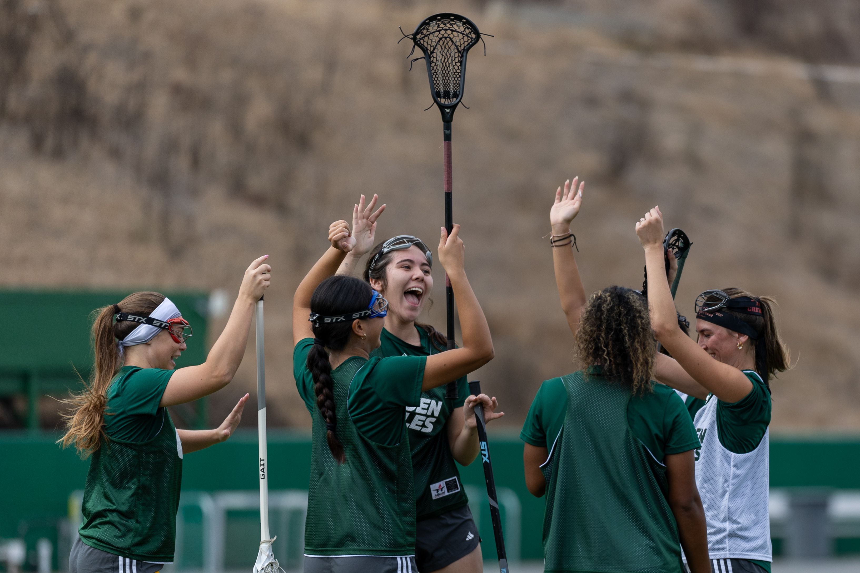 Teammates celebrate together during practice 